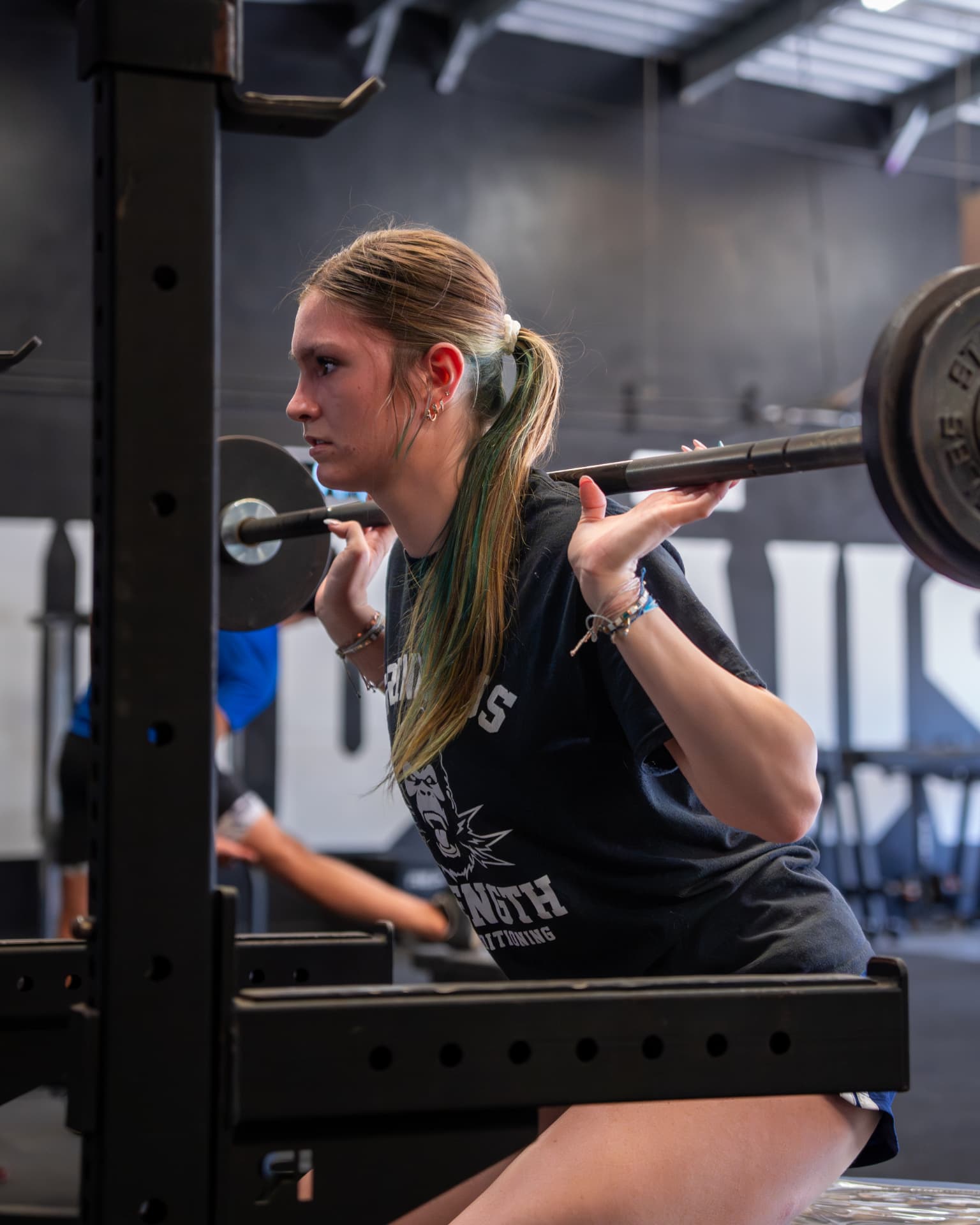 Athlete squatting in the rack